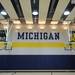 Photographs of the men's and women's basketball teams hang on the wall in the basketball court area at  the Player Development Center during a tour on Tuesday. Melanie Maxwell I AnnArbor.com